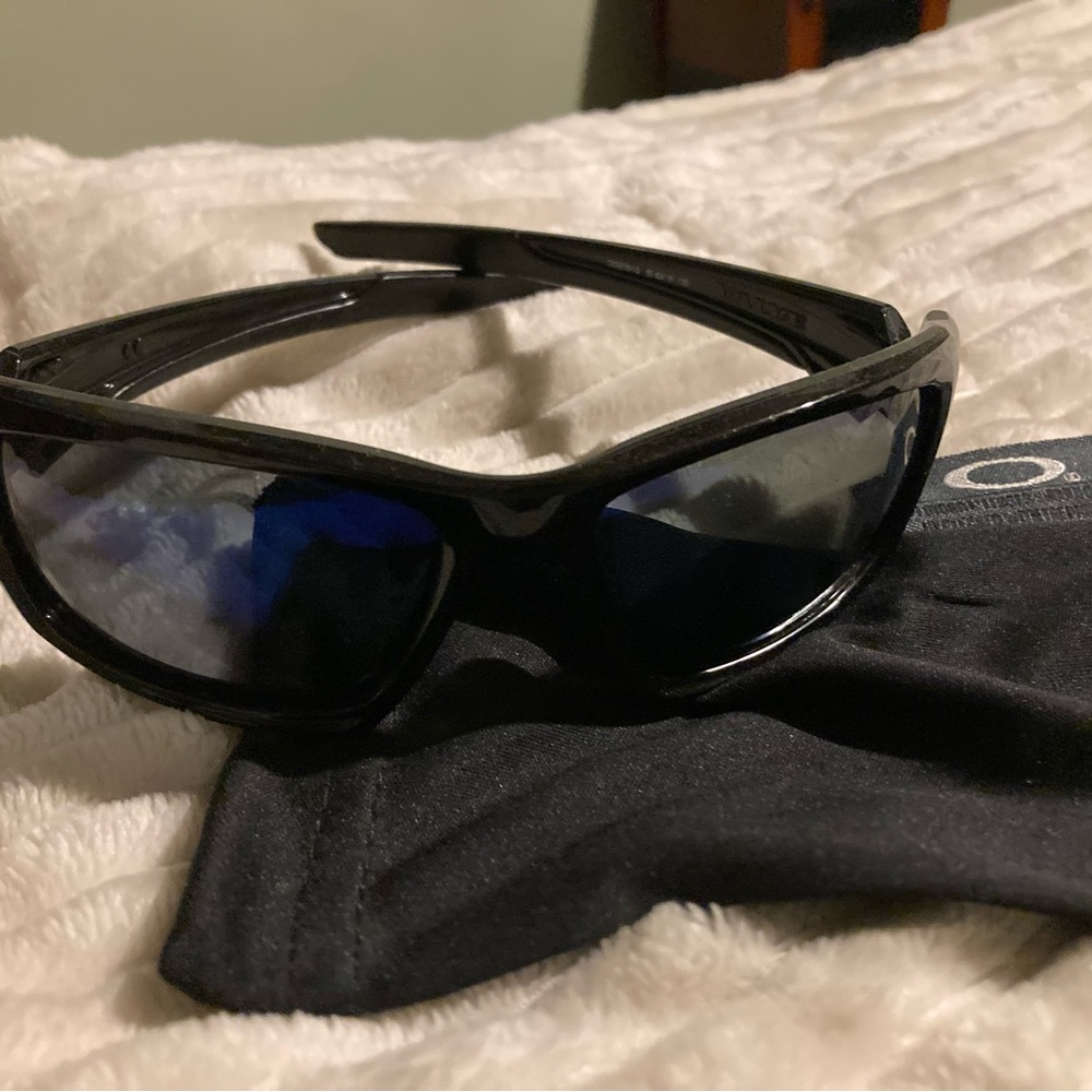 Oakley Dark Frame Sunglasses with Reflective Blue Lenses